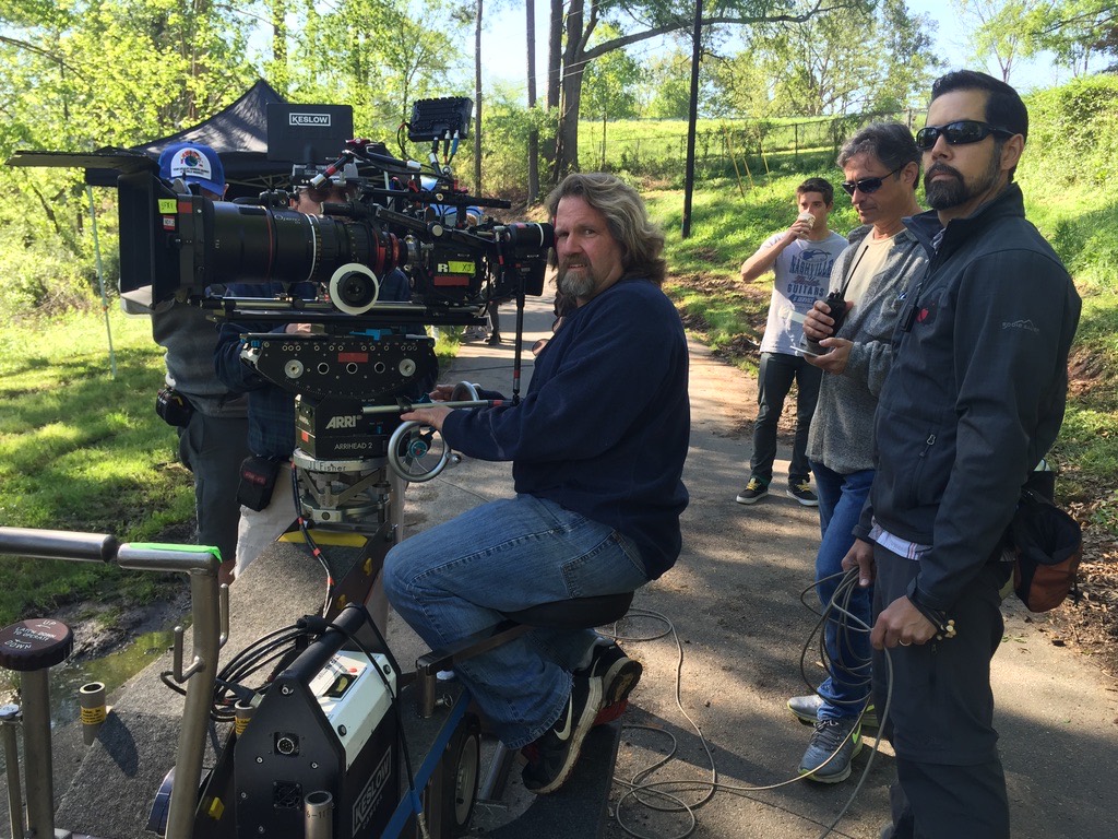Ed Gutentag operating an ARRI camera on a geared head with film crew
