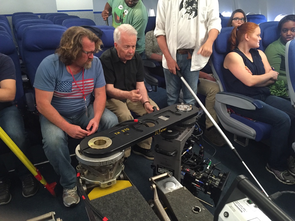 Ed Gutentag with a JL Fisher dolly on an aircraft-cabin film set