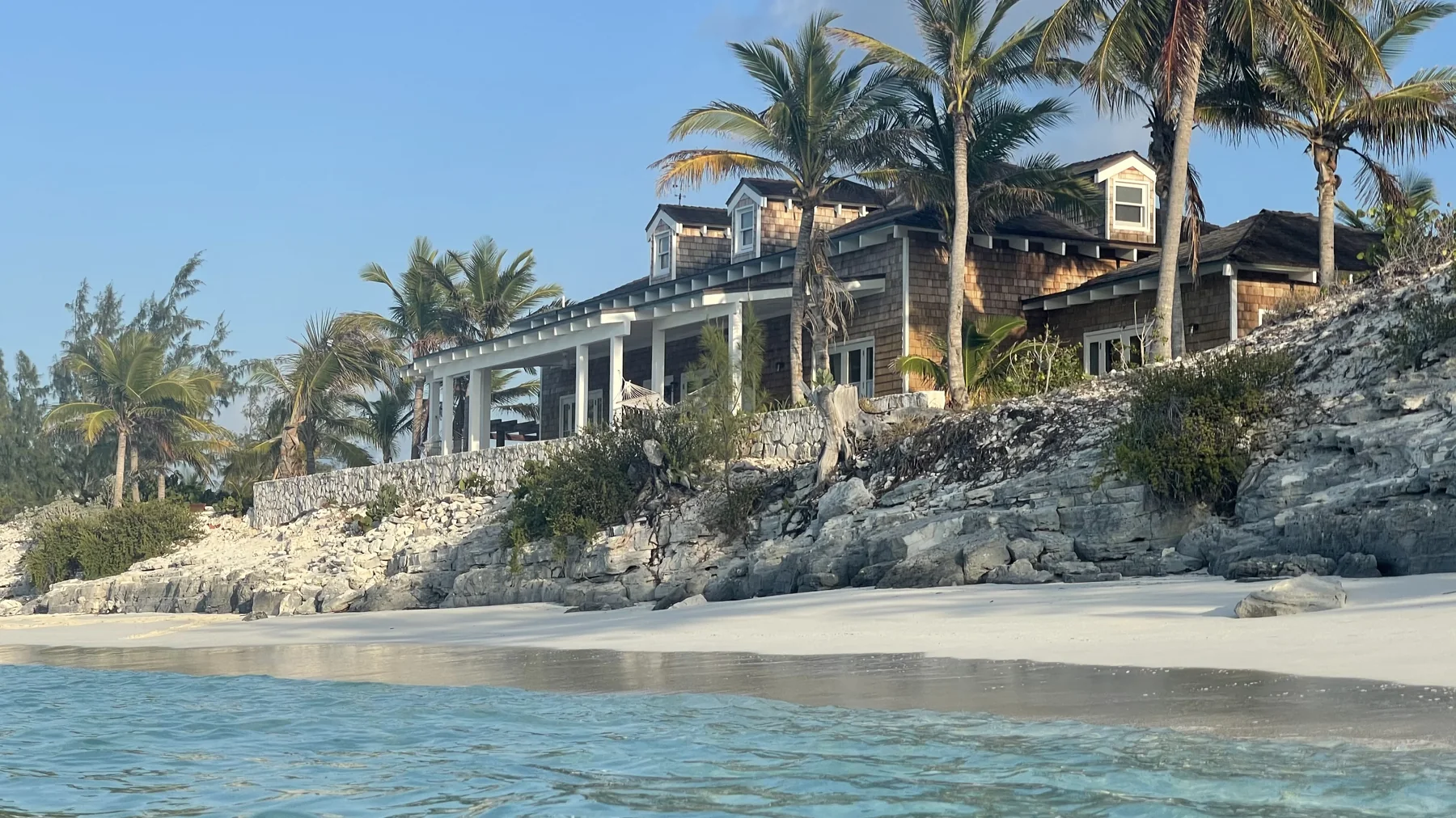 Coastal home with palm trees on the beach