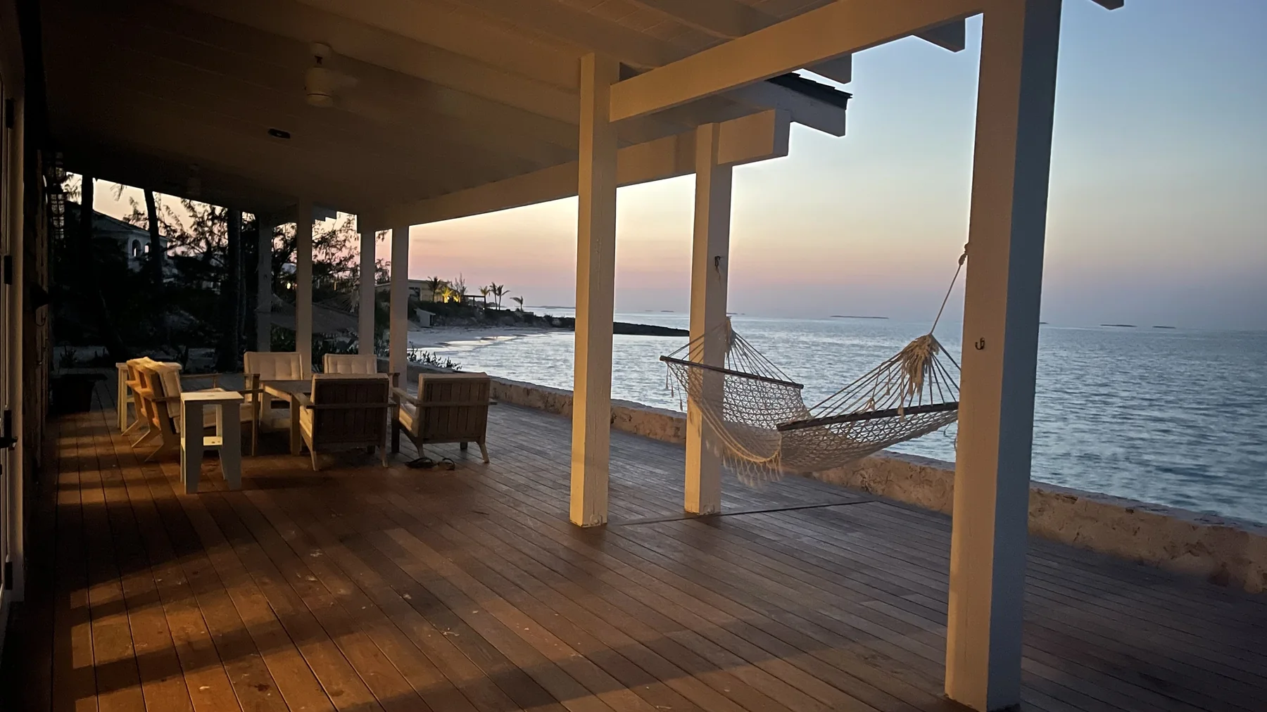 Hammock and dining deck at golden hour overlooking the Gulf