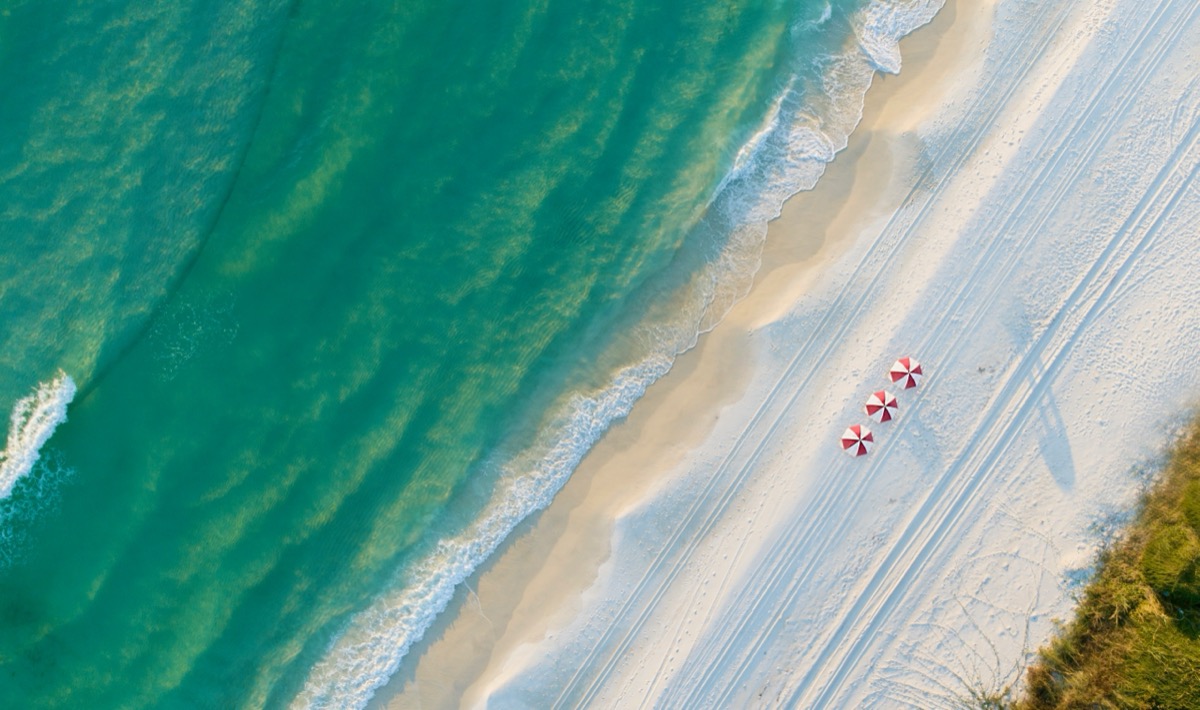 Aerial of beach umbrellas on the white sand, Emerald Coast