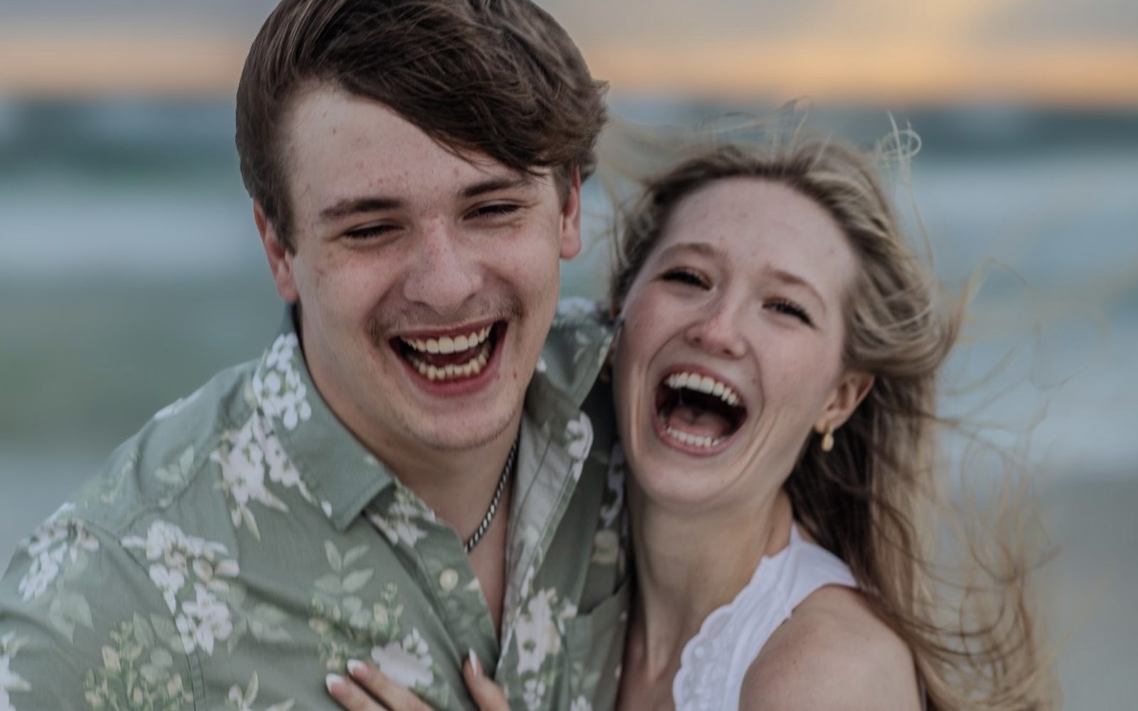 Couple laughing together at golden hour on the Emerald Coast, Panama City Beach