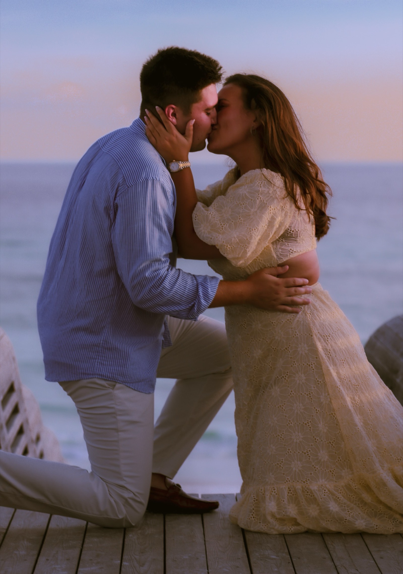 Newly engaged couple kissing at sunset, Panama City Beach