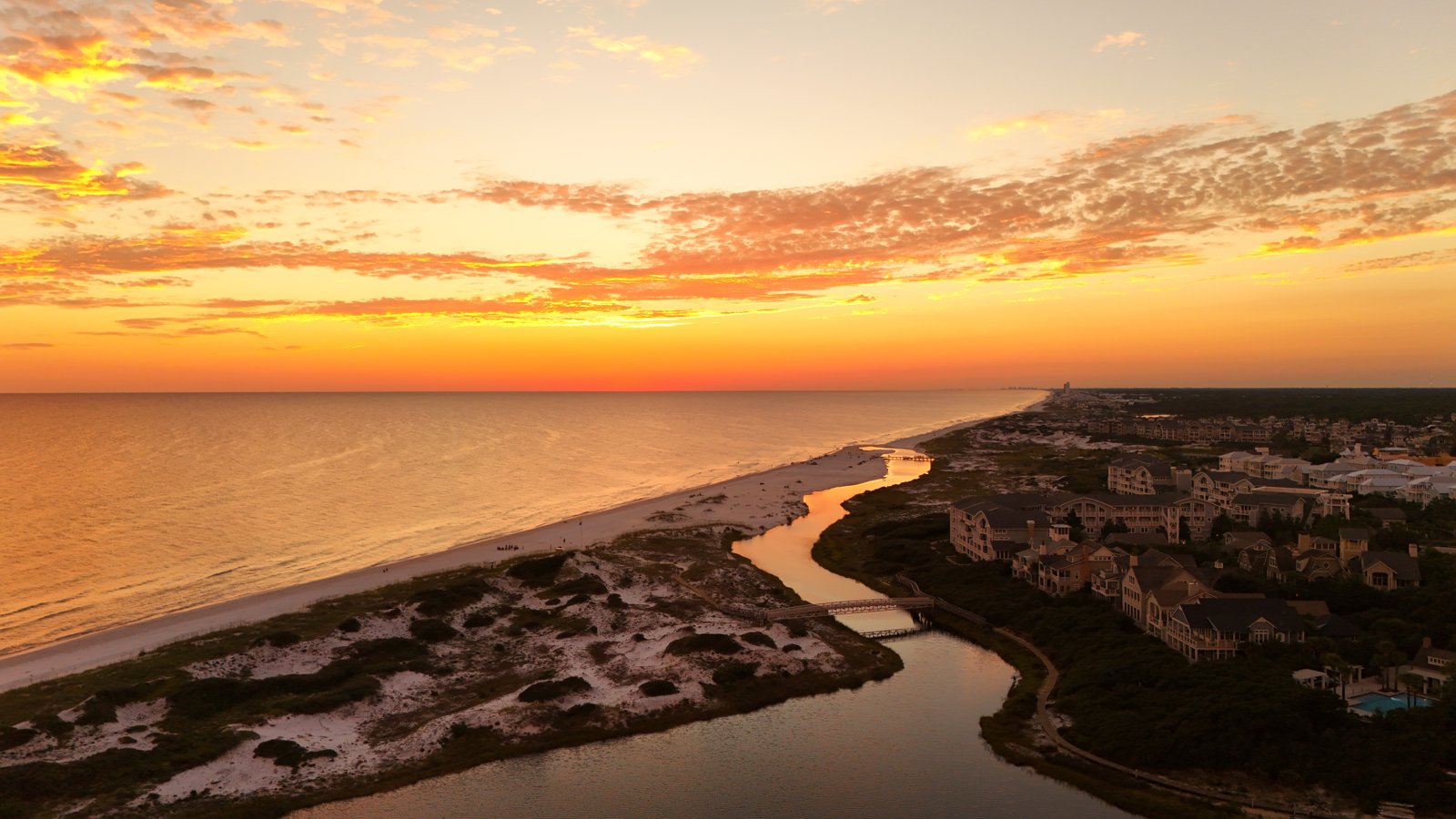 Aerial golden-hour sunset over a dune lake — Ed Gutentag